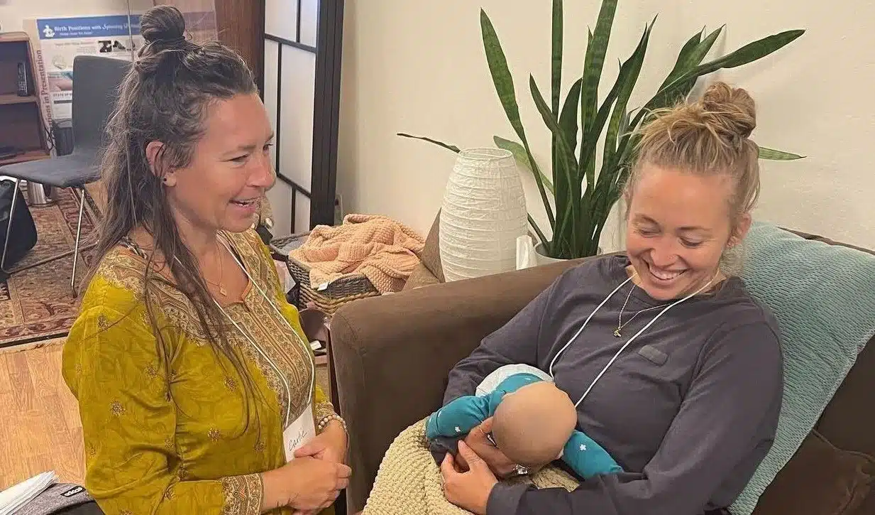 2 women learning breastfeeding techniques in Doula Training