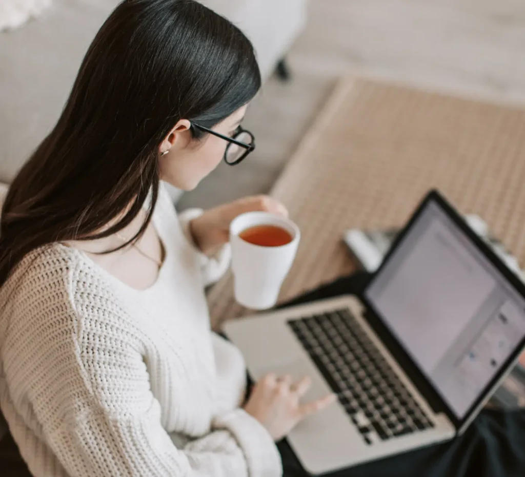 Woman running her doula business from laptop